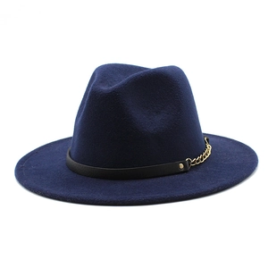 Detail of navy wool fedora with decorative black band and delicate gold metal chain