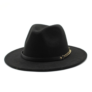 Detail of black wool fedora featuring gold chain and rivet accents on the hat band