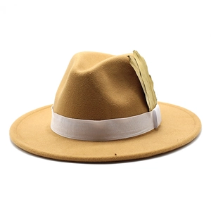 Classic camel wool fedora hat with white ribbon and golden leaf ornament on white background