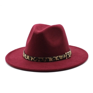 Close-up of wine red fedora hat with leopard print band and golden metal buckle detail