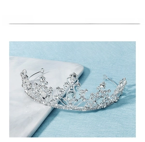 Detailed close-up of a silver luxury bridal crown with hollow engraving and zircons