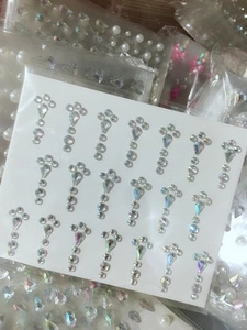 Macro shot of self-adhesive teardrop and round rhinestones for face and nail art DIY