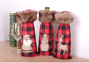 Detail of red and black plaid Christmas wine bottle covers with gnome and reindeer embroidery