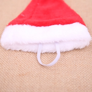 Red and white plush Christmas pet hat with elastic strap for cats and dogs festive party wear