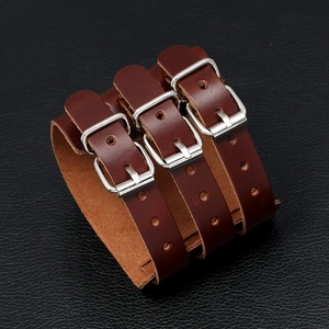 Close-up of brown leather biker bracelet with silver metal buckles and multi-row straps