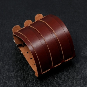 Close-up of brown multi-layer leather motorcycle bracelet with vintage metal buckles