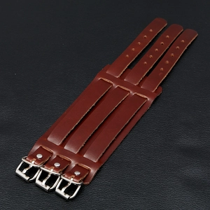 Close-up of brown leather biker bracelet featuring three adjustable silver buckle straps