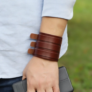 Men's punk vintage multilayer leather bracelet with metal buckle on wrist outdoors