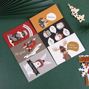 Close-up of assorted vintage Christmas greeting cards with cartoon animal gold foil prints