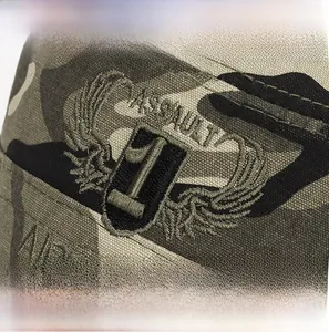 Macro view of detailed embroidery badge on a camouflage tactical flat top cap fabric