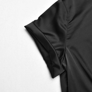 Close-up of the rolled cuff detail on a black satin crop top with smooth fabric texture
