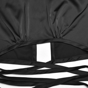 Detail view of the black satin crop top featuring sleek crisscross back lace-up straps