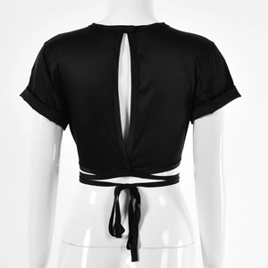 Detail view of black cropped top featuring open back design and adjustable waist ties