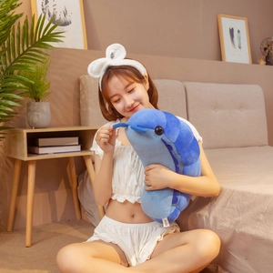 Blue ocean creature caterpillar plush toy displayed in a cozy bedroom setting