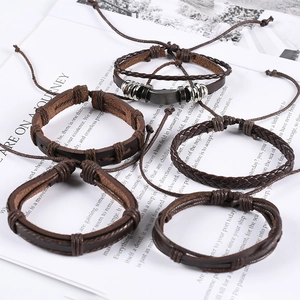 5-piece vintage brown leather and braided rope bracelet set on an open book