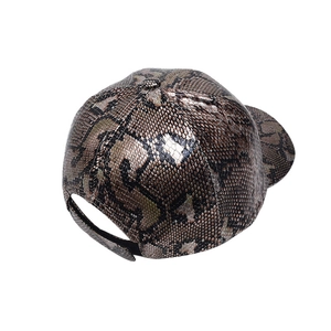 Detail view of adjustable back strap on brown faux snakeskin baseball cap