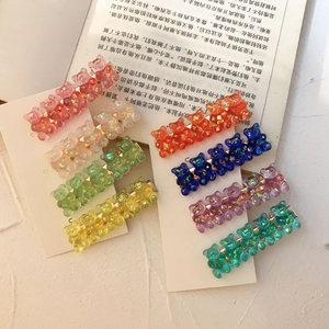 Detail view of eight glittery bear hair clips in assorted colors on display cards