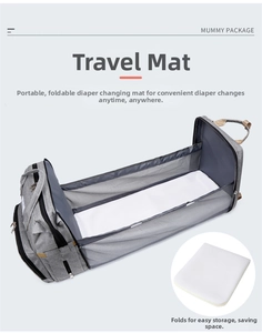 Close-up of the foldable grey diaper bag unfolding into a portable travel crib with soft mat