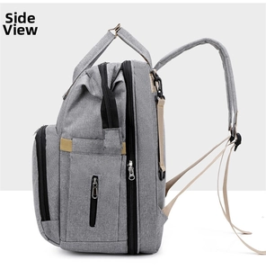 Side view of multi-functional grey diaper backpack with pockets and durable straps