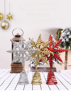 Three-color glitter snowflake tree toppers in gold, silver, and red with spring bases