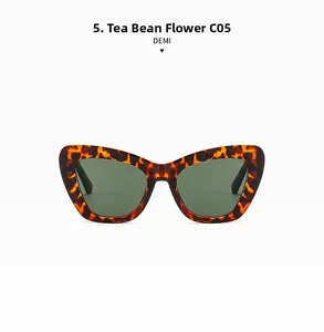 Close-up of stylish oversized tortoiseshell cat-eye sunglasses with dark green lenses