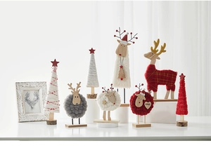 Close-up of wool felt reindeer and sheep figurines with wooden base for Xmas decor