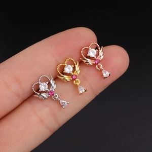 Three winged heart belly rings in silver, gold, and rose gold with teardrop zirconia