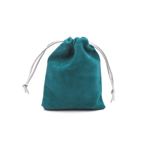 Detail view of dark teal velvet jewelry pouch with silver grey drawstring closure