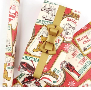 Detail of vintage Christmas wrapping paper with red nutcrackers and golden ribbons