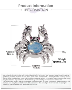 Close-up of crab brooch with blue gemstone, white rhinestones and size dimensions