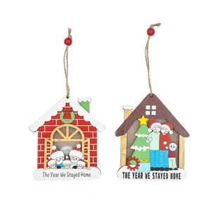 Wooden Christmas house ornaments with masks and The Year We Stayed Home slogan