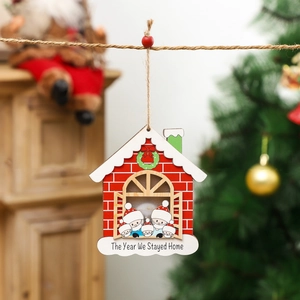 Christmas wooden house ornament with masked figure and The Year We Stayed Home text