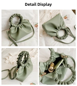 Detail showing bean green ruched handbag interior capacity with phone and cosmetics