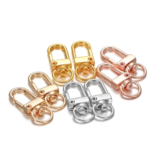 Macro detail of assorted metal swivel lobster clasps in gold silver and rose gold finishes