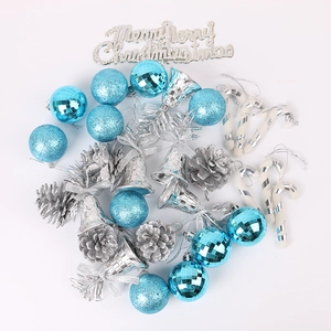 Detailed flat lay of blue disco balls, silver pinecones, and Merry Christmas sign set