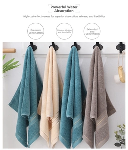 Close-up of premium long-staple cotton towels with gold thread trim and hanging hooks