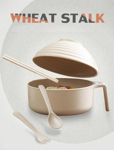 Macro shot of wheat stalk noodle bowl set with floating lid, spoon and chopsticks