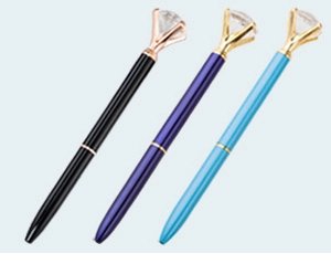 Detail of slim ballpoint pens with large diamond crystal toppers in various elegant colors