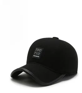 Detail of black winter baseball cap showing TUC TIC rubber patch and wool texture