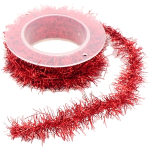 Metallic red tinsel ribbon with fringe texture on a spool for Christmas gift wrapping