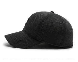 Close-up of side view of thick dark grey wool baseball cap with minimalist logo patch
