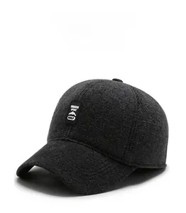 Detail of dark gray wool blend fabric with Outdoor Sport Golf patch on the winter cap
