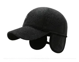 Detailed side view of dark grey winter wool baseball cap with thick ear flaps and patch