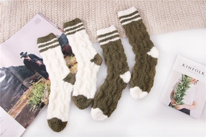 Detail of coral fleece sleeping socks with cable knit texture and striped patterns