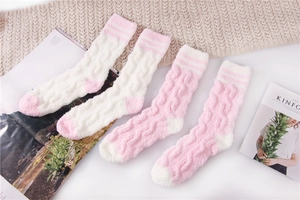 Detail of pink and white striped coral fleece sleep socks with cable knit texture
