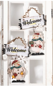 Detail of rustic Welcome Christmas sign featuring snowmen with red hats and candy canes