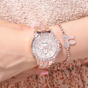 Rose gold women's watch with rhinestones and matching bow bracelet set on a wrist