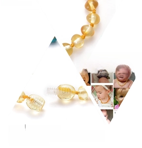 Detail of Baltic amber baby bracelet showing secure screw clasp and knotted safety design