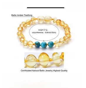 Detail view of Baltic amber baby bracelet with turquoise beads and 15cm size specs