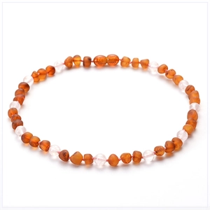 Baltic amber baby necklace with crystal and turquoise beads on a white background